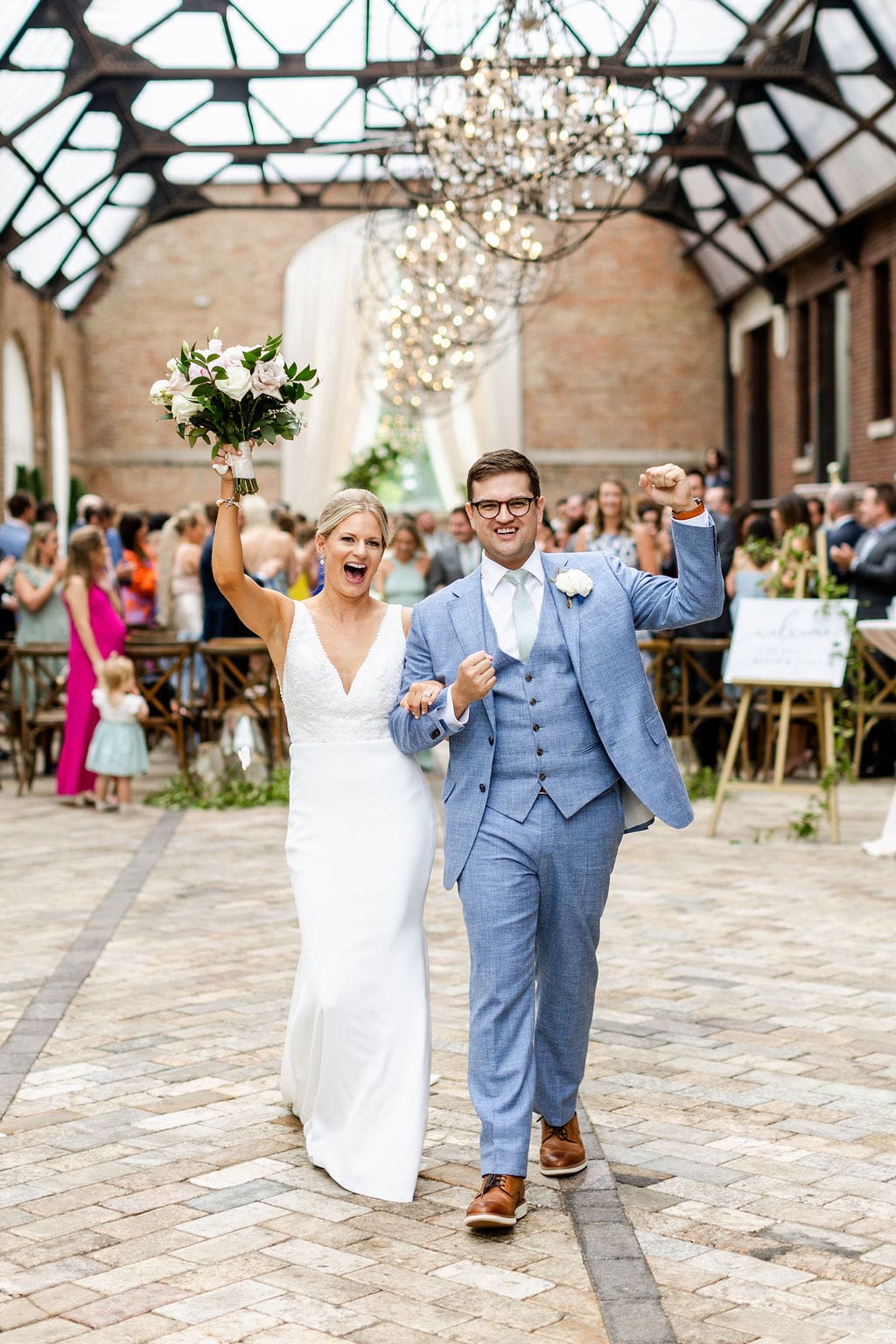 Excited couple exit their Bridgeport Art Center wedding ceremony