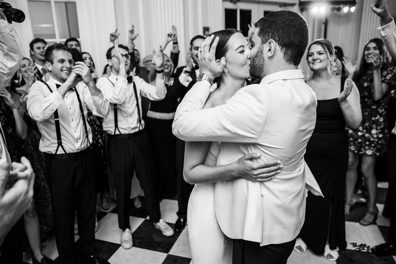 Bride and groom kiss on the dance floor at their Chicago History Museum wedding reception