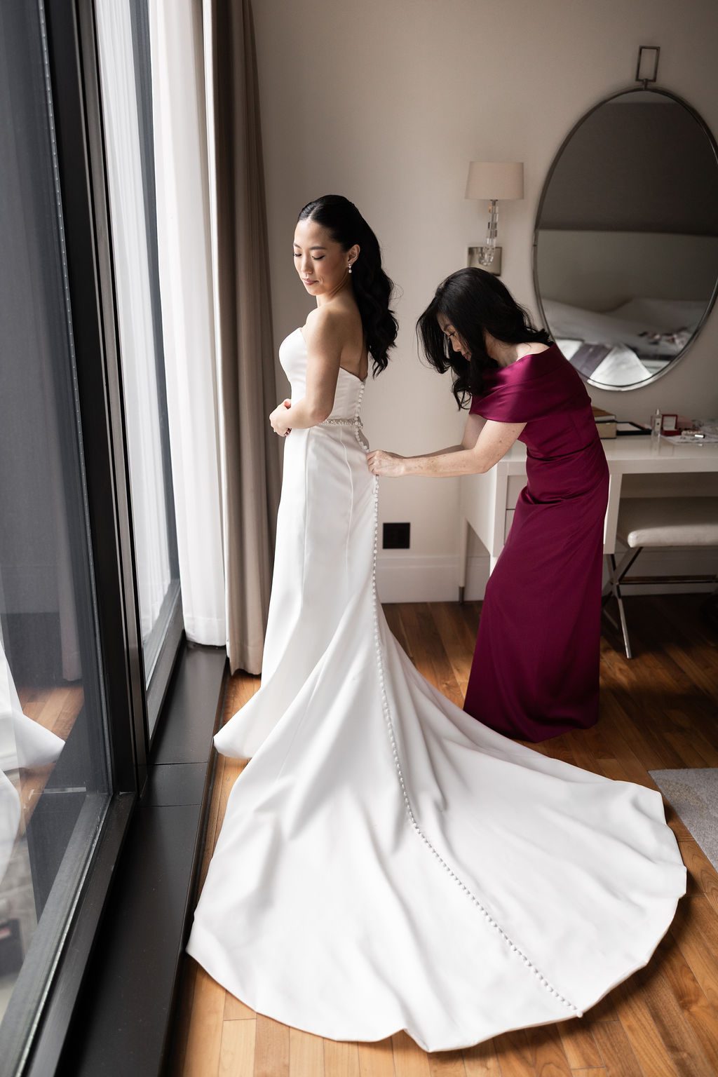 Bride getting into wedding dress at The Langham Chicago