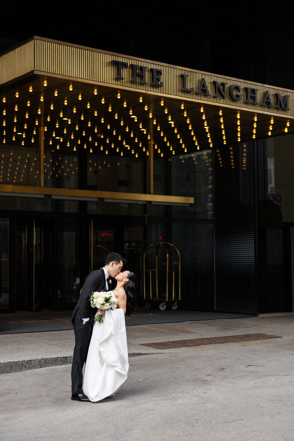 Bride and groom outside of the Langham Chicago