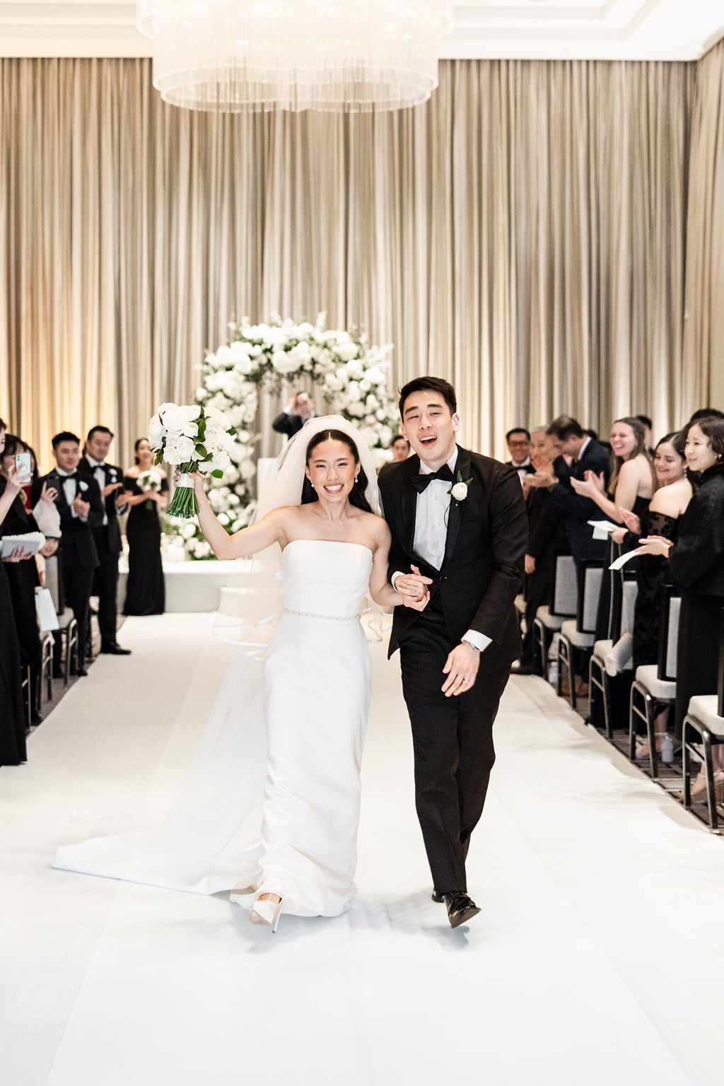 Bride and groom exit Langham Chicago wedding ceremony