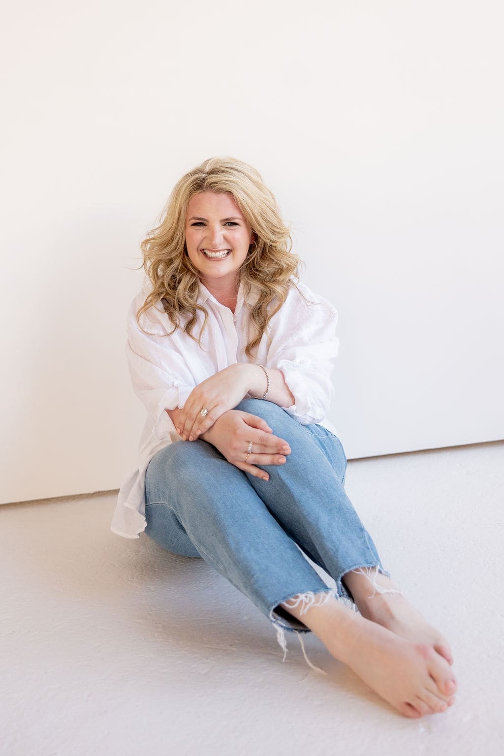 Woman smiles at the camera during boudoir photoshoot in Chicago