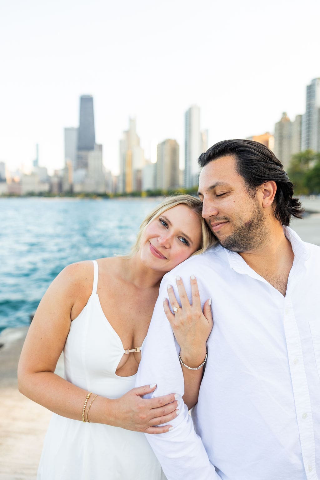 Woman rests head on man's shoulder during North Avenue Beach engagement photos