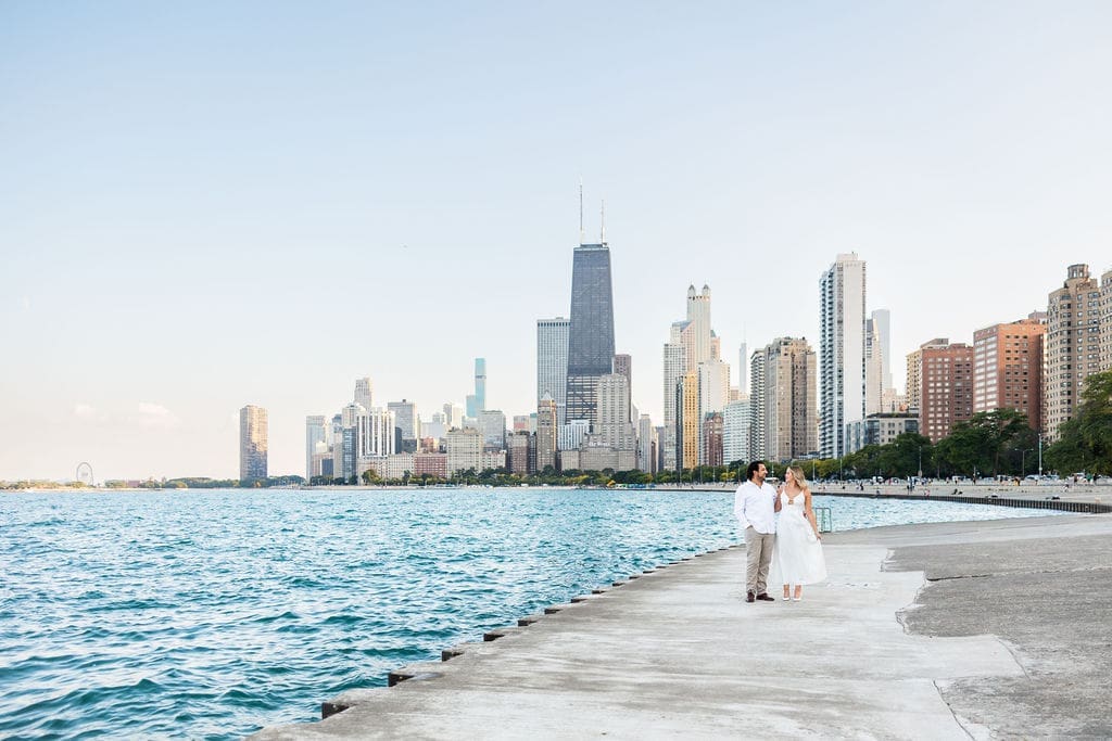 Man and woman with Chicago skyline backdrop at their North Avenue Beach engagement photos