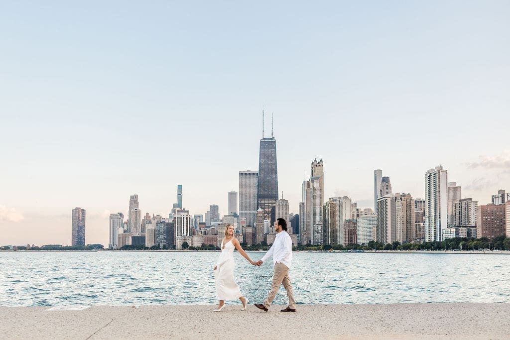 Couple walks holding hands at North Avenue Beach in Chicago