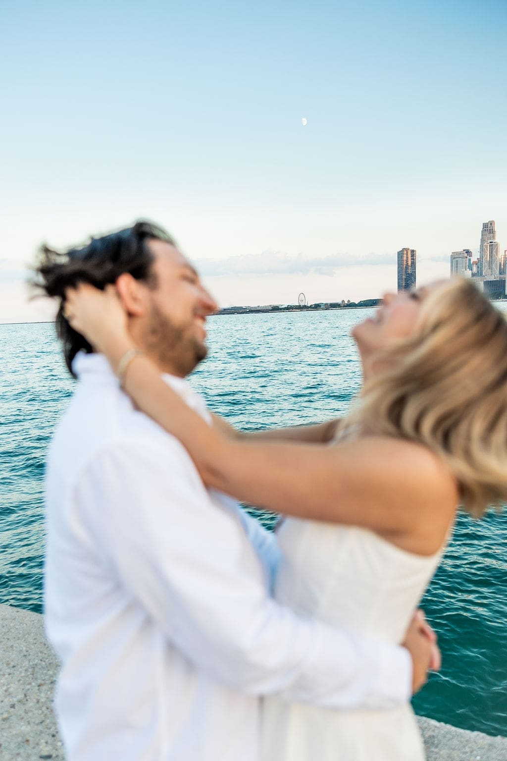 Man and woman have fun during North Avenue Beach engagement session