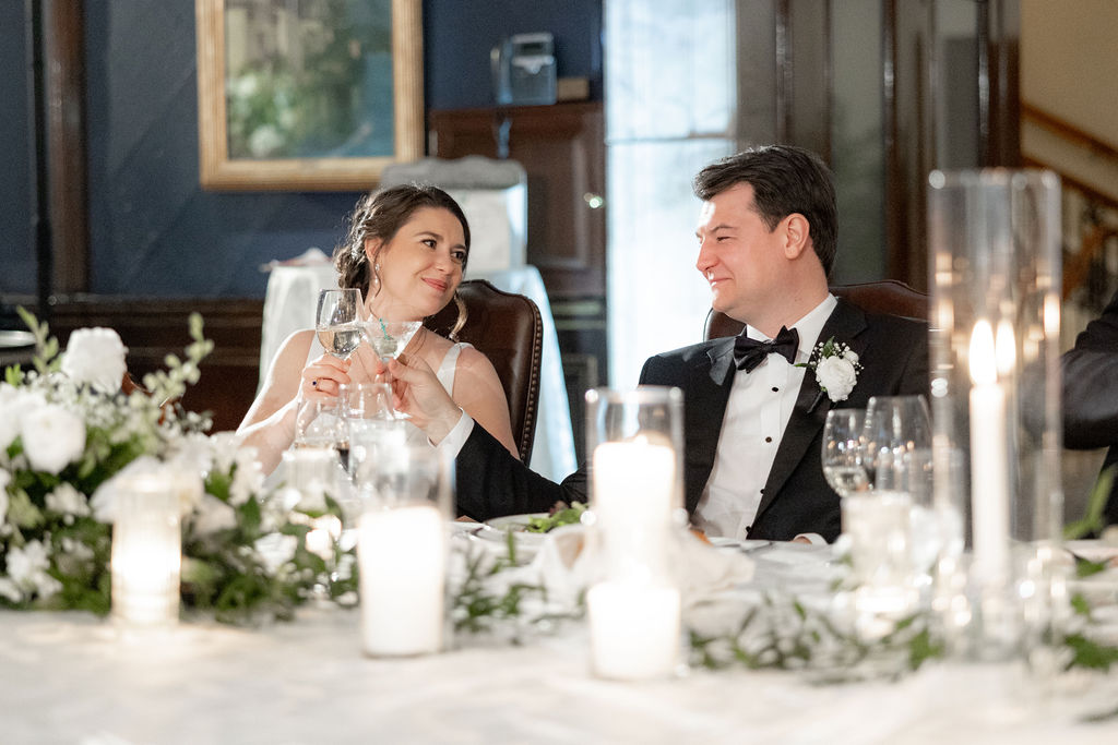 Couple enjoys wedding toasts at their Union League Club wedding reception